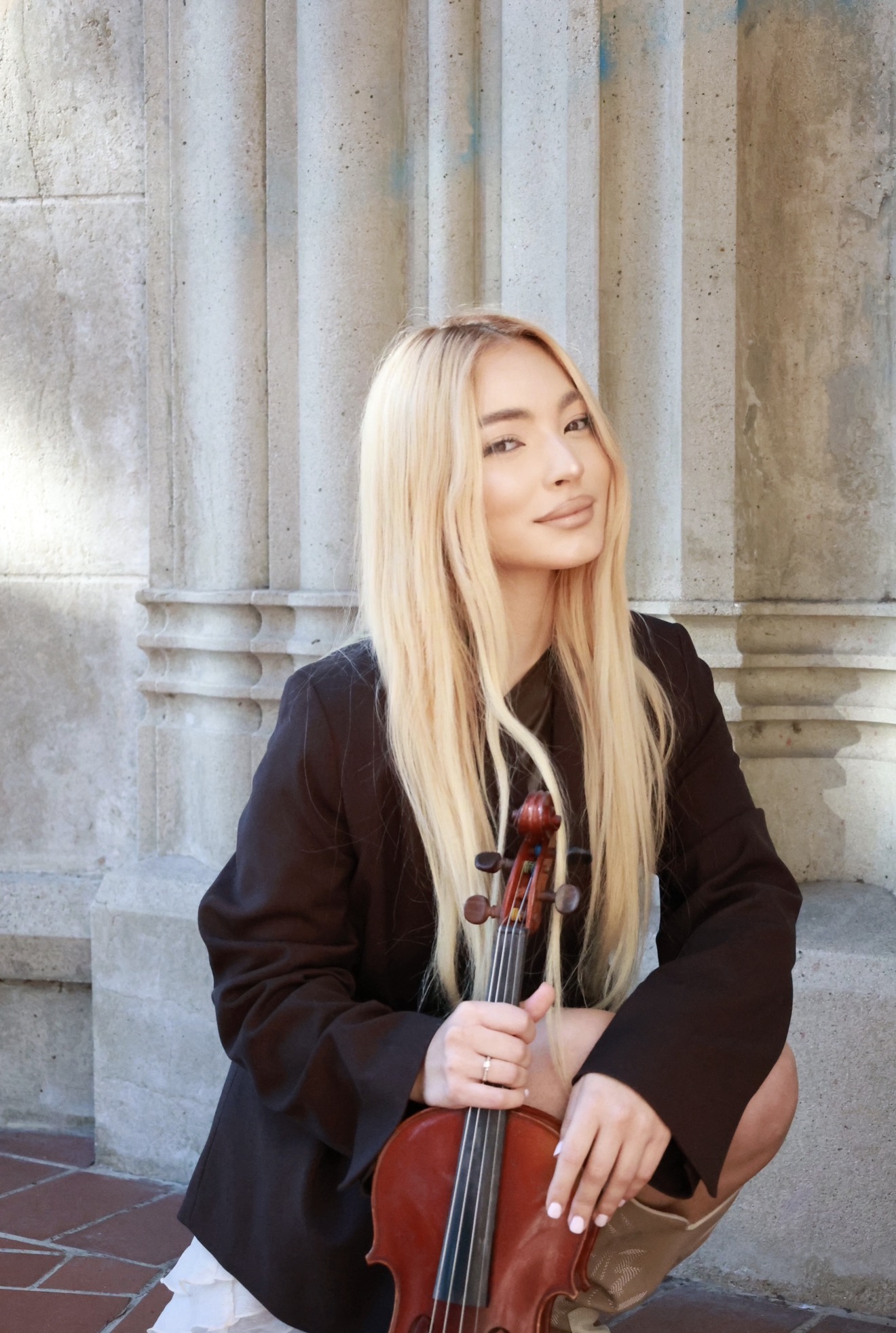 Asya Anisimova holding her violin