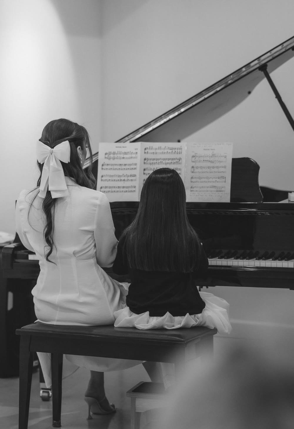 Teacher and student at a grand piano