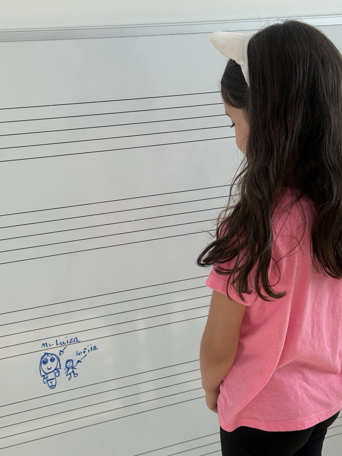 A student’s drawing of Ms. Luiza during a music lesson