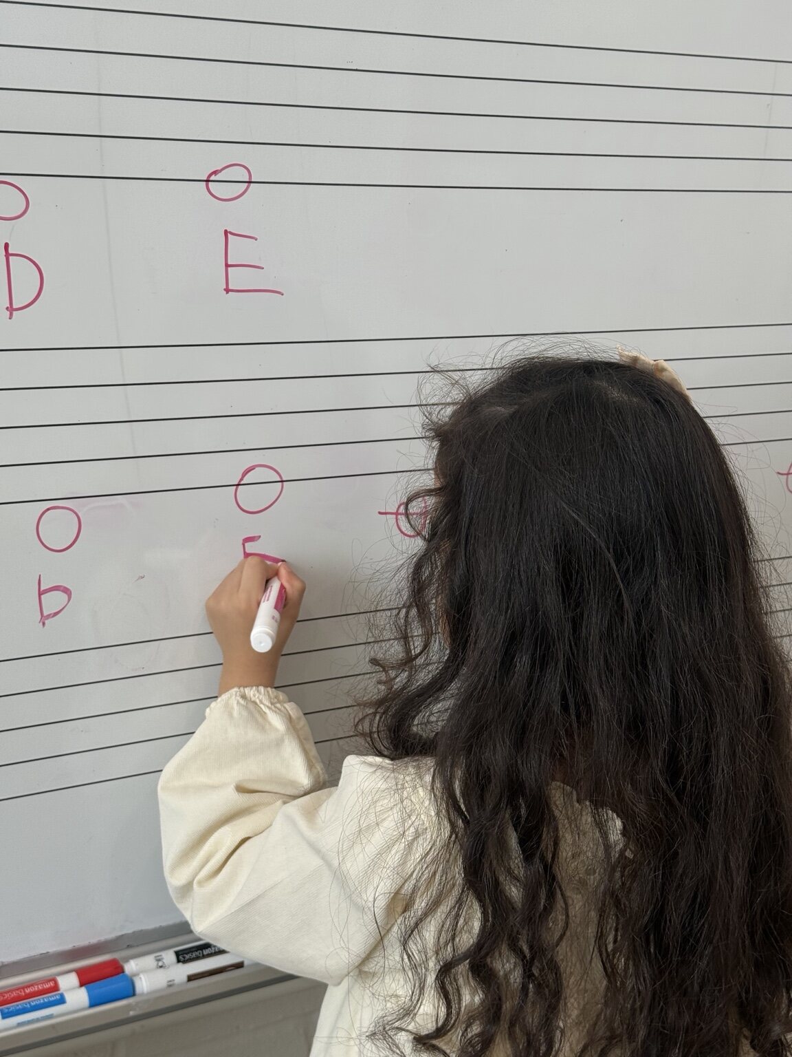 A student learning notes on the music board